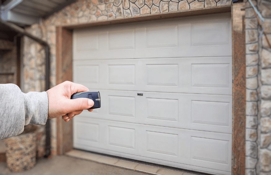 person pointing remote at garage door