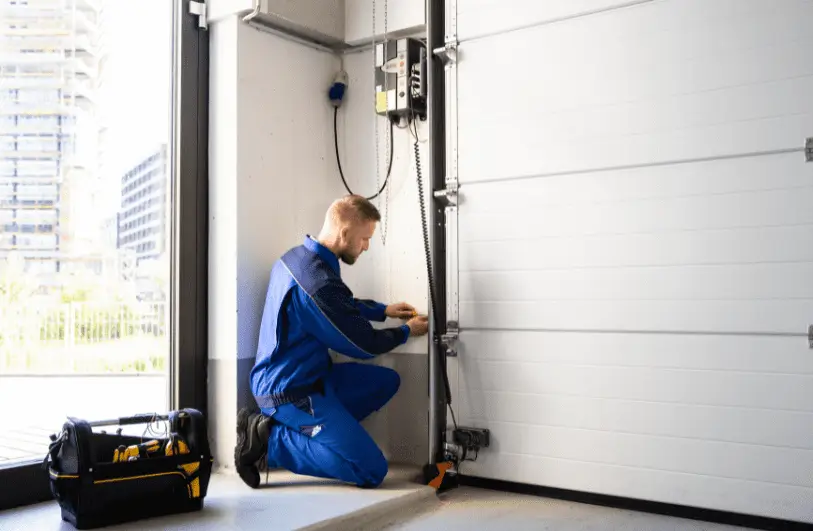 professional garage door repair man working on a door